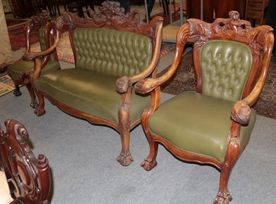 Lot 1314 - An elaborately carved Victorian settee and two chairs