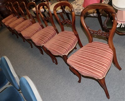 Lot 1326 - A set of six Victorian balloon back dining chairs, with overstuffed seats, raised on simulated...