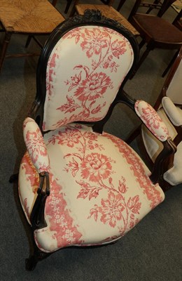 Lot 1327 - A late 19th/early 20th century ebonised framed fauteuil with floral upholstery