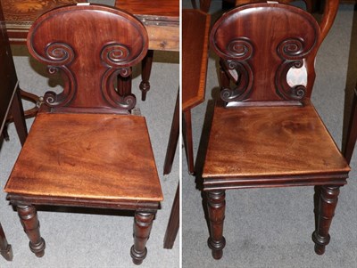 Lot 1340 - A pair of George IV mahogany hall chairs, with solid seats and turned legs, 47cm wide