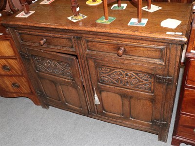 Lot 1356 - A reproduction carved oak sideboard, 121cm wide