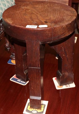 Lot 1359 - An oak Arts and Crafts three legged stool