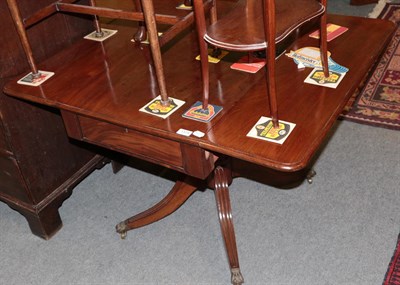 Lot 1374 - A Regency mahogany drop leaf sofa table on reeded legs, 91cm wide