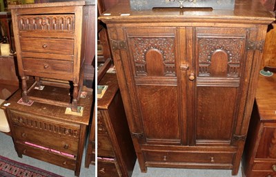 Lot 1375 - A reproduction oak two-door cupboard, the base with a long drawer; a reproduction oak...