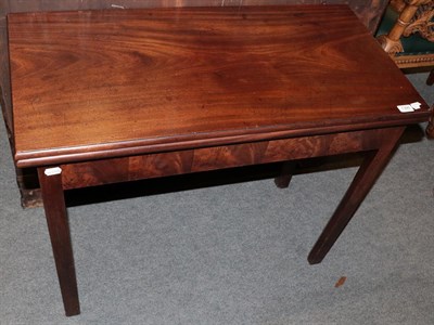 Lot 1395 - A George III mahogany fold over tea table on square chamfered legs, 91cm