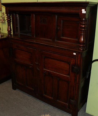 Lot 1400 - An early 18th century joined oak court cupboard, with moulded cornice above a central panel...