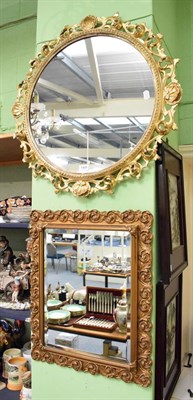 Lot 1409 - A carved giltwood circular wall mirror; and a 20th century bevelled glass mirror (2)