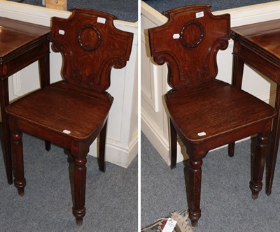 Lot 1414 - A pair of Victorian carved oak hall chairs, 43cm wide