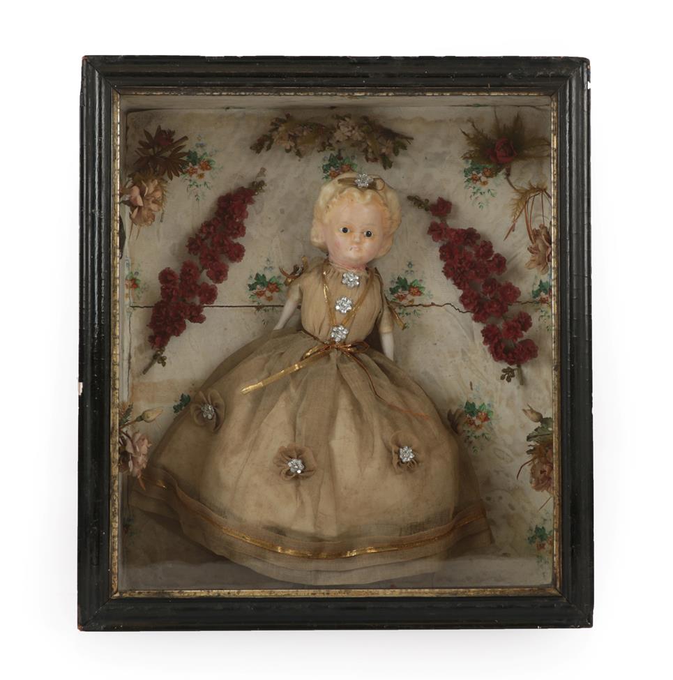 Lot 2011 - An Early 19th Century Diorama, of a wax pumpkin head doll with brown eyes, in a fine dress...