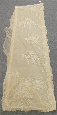 Lot 2077 - Late 19th Century Limerick Lace Flounce, with large sprays of flowers within a scalloped...