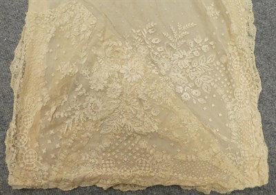Lot 2077 - Late 19th Century Limerick Lace Flounce, with large sprays of flowers within a scalloped...
