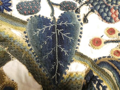 Lot 2108 - 18th Century Wool Crewelwork Motifs, cut and stitched on to a later white linen cloth,...