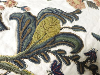 Lot 2108 - 18th Century Wool Crewelwork Motifs, cut and stitched on to a later white linen cloth,...