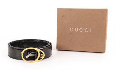 Lot 2289 - Gucci Black Patent Leather Belt, with gilt metal hooped buckle with small interlocking GG to...