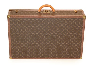 Lot 2319 - Louis Vuitton Monogram Leather Hard Suitcase, trimmed in brown studded leather, the brass clasp...