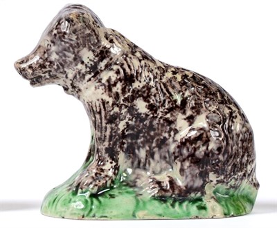 Lot 7 - A Creamware Model of a Bear, late 18th century, the naturalistically modelled animal seated...