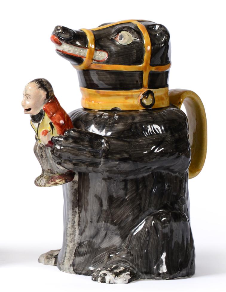 Lot 11 - A Pearlware Bear Jug, early 19th century, the seated animal with grey fur, ochre muzzle, collar and