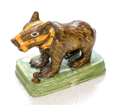 Lot 12 - A Pratt-Type Model of a Bear Cub, circa 1800, the standing animal with brown markings and ochre...