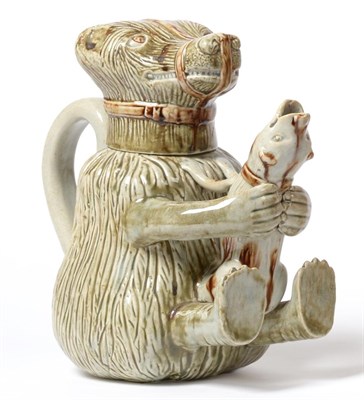 Lot 19 - A Pearlware Bear Jug and Cover, circa 1800, the muzzled beast clutching a struggling dog...
