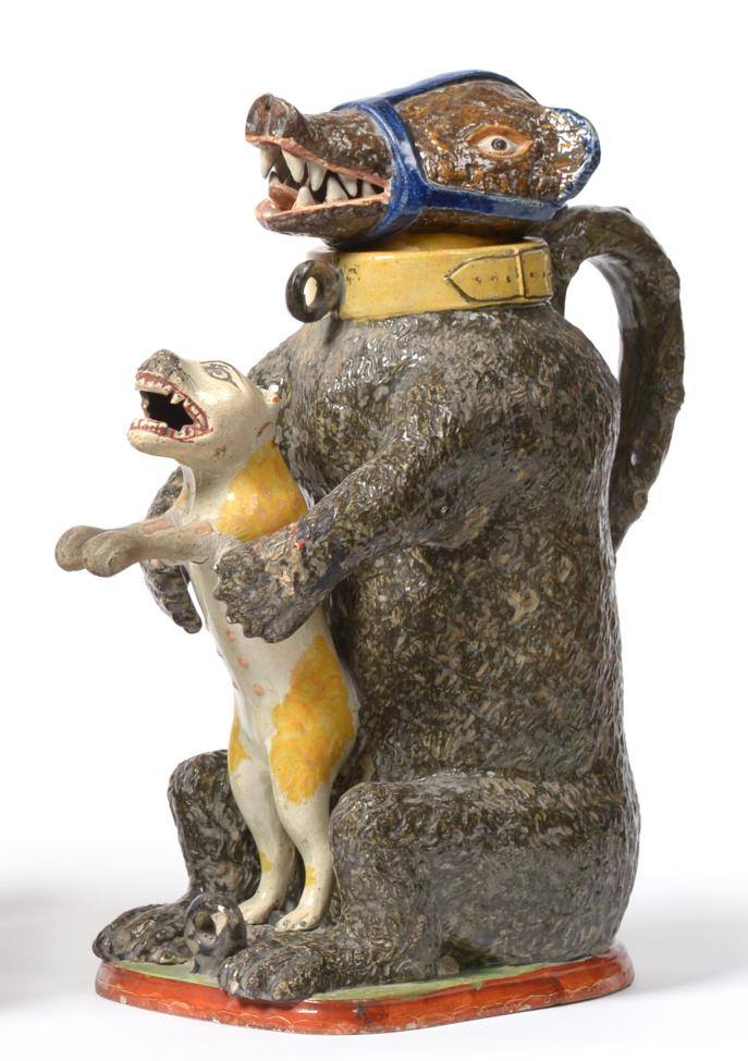 Lot 21 - A Prattware Bear Jug, circa 1800, the seated beast with muzzle and collar clutching a...