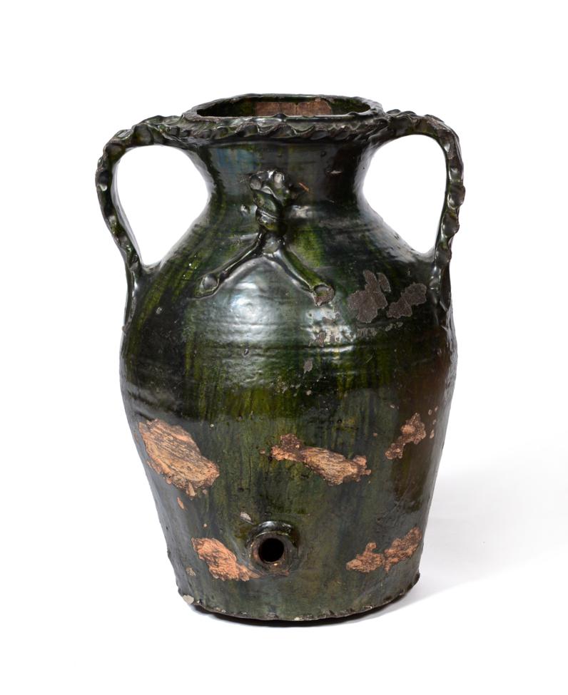 Lot 38 - An Italian Green Glazed Pottery Oil Jar, in 16th century style, of baluster form with frilled...