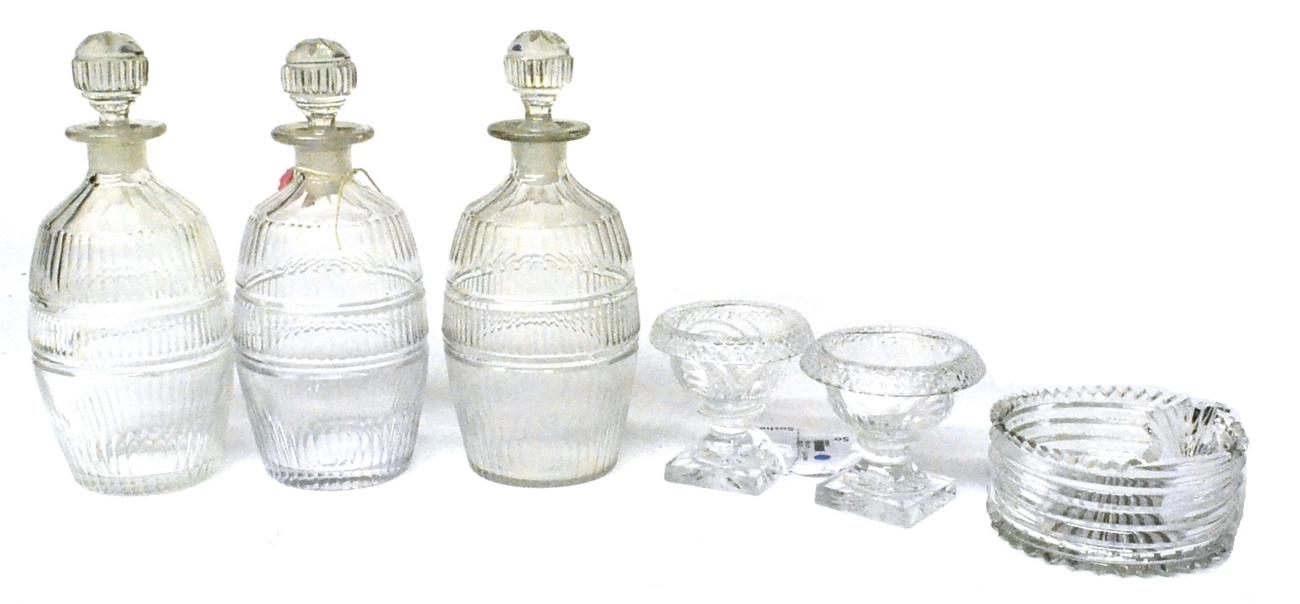 Lot 70 - A Set of Three Decanters and Stoppers, mid 19th century, of barrel form, cut with bands of...