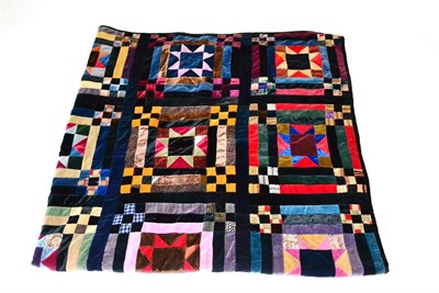 Lot 159 - A Late 19th Century Patchwork Quilt using printed and coloured velvets with a black velvet trim and