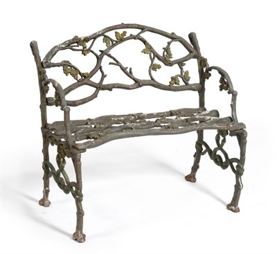 Lot 257 - A Cast Iron Garden Seat, of naturalistic branch form decorated with leaves and berries, 90cm by...
