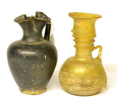 Lot 266 - A Roman Style Black Glazed Ewer, with trefoil neck, 17.5cm high; and An Amber Glass Bottle,...