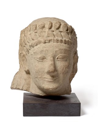 Lot 270 - A Carved Stone Head of an Egyptian, with leaf head band, 27cm high, on marble plinth