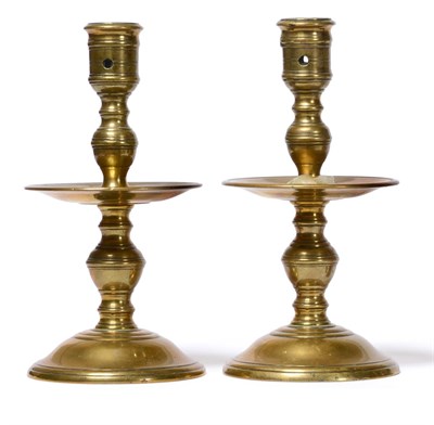 Lot 277 - A Pair of 17th Century Brass Candlesticks, the urn shaped sconces on baluster stems, circular...