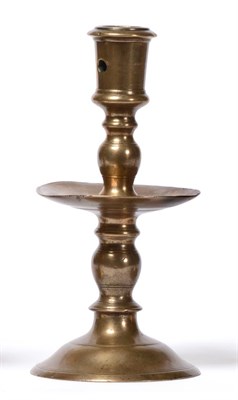 Lot 278 - A 16th Century Dutch Brass Candlestick, the urn shaped sconce on a baluster stem, circular drip pan