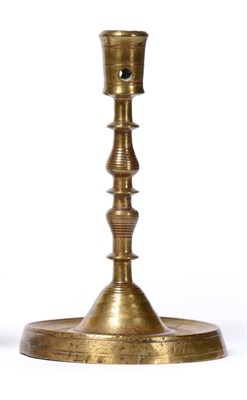 Lot 279 - A 16th Century Dutch Brass Candlestick, the bucket shaped sconce on a knopped baluster stem and...