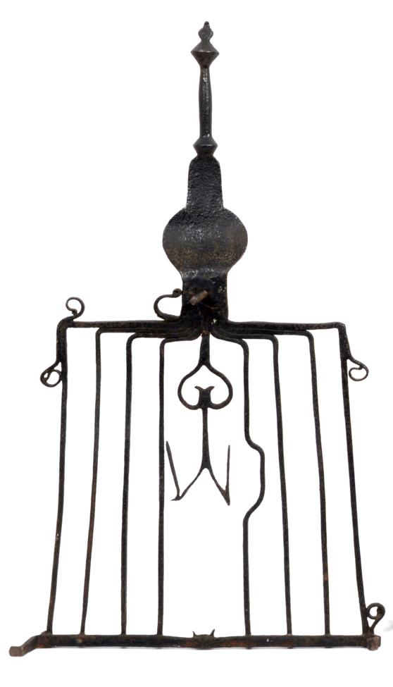 Lot 280 - A Wrought Iron Gridiron or Trivet, 17th century, with baluster handle and heart and scroll...