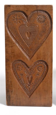 Lot 323 - A Treen Gingerbread Mould, 19th century, with two chip carved heart shaped panels, 49cm by 23cm