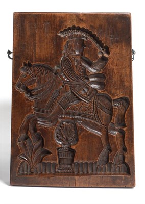 Lot 324 - A Treen Gingerbread Mould, 19th century, carved with a knight on horseback, the reverse with a...