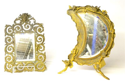 Lot 351 - A Gilt Metal Easel Back Table Mirror, in Aesthetic style, the crescent moon shaped plate within...