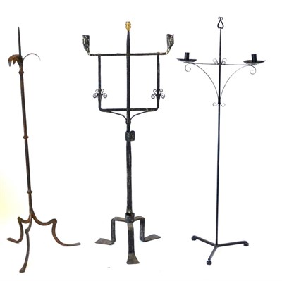 Lot 412 - An Iron Two-Branch Candle Holder, with stylised scrolled brackets and tripod base, 130cm high;...