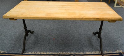 Lot 437 - A Scrubbed Pine Kitchen Table, of plank construction, raised on cast iron turned supports,...