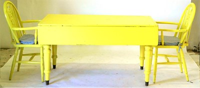 Lot 458 - A Late 19th Century Kitchen Table, painted yellow, the rectangular top with two narrow hinged...