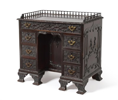 Lot 462 - A Mahogany Kneehole Desk, in the Chippendale Gothic style, with a spindled gallery, seven...