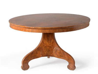 Lot 467 - A Continental Walnut Loo Table, the circular radially veneered top raised on a three-sided...