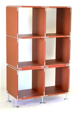 Lot 497 - A Porro Endless Shelving System, a rust orange finish, six open square sections, unmarked, on...