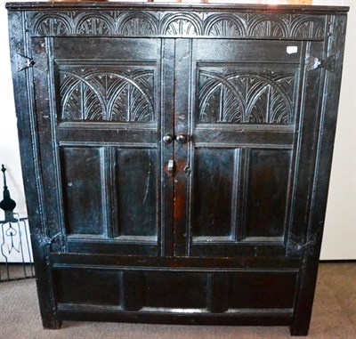 Lot 514 - A 17th Century Joined Oak Hanging Press, with a lunette carved frieze over two doors, the upper...