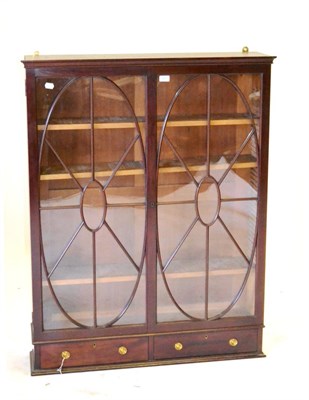 Lot 524 - A Mahogany Bookcase, with two oval glazed doors enclosing adjustable shelves, with two small...