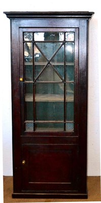 Lot 530 - A 19th Century Stained Pine Cabinet, the ogee cornice over a glazed door enclosing shelves,...