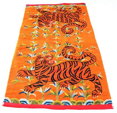 Lot 540 - Tibetan Tiger Rug Central Tibet The tangerine field depicting two roaring tigers in a bamboo...