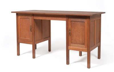 Lot 546 - A Gordon Russell Oak Desk, circa 1930, design No.893, rectangular top over two cupboard doors,...