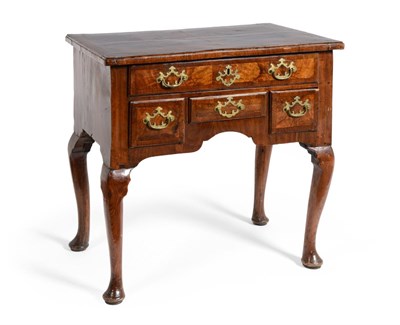 Lot 556 - A George II Walnut Veneered Lowboy, the quarter-veneered top over a frieze drawer and three...