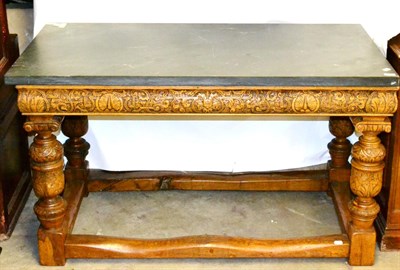 Lot 568 - An Elizabethan Style Table, with a rectangular grey slate top, on a carved oak frame with...